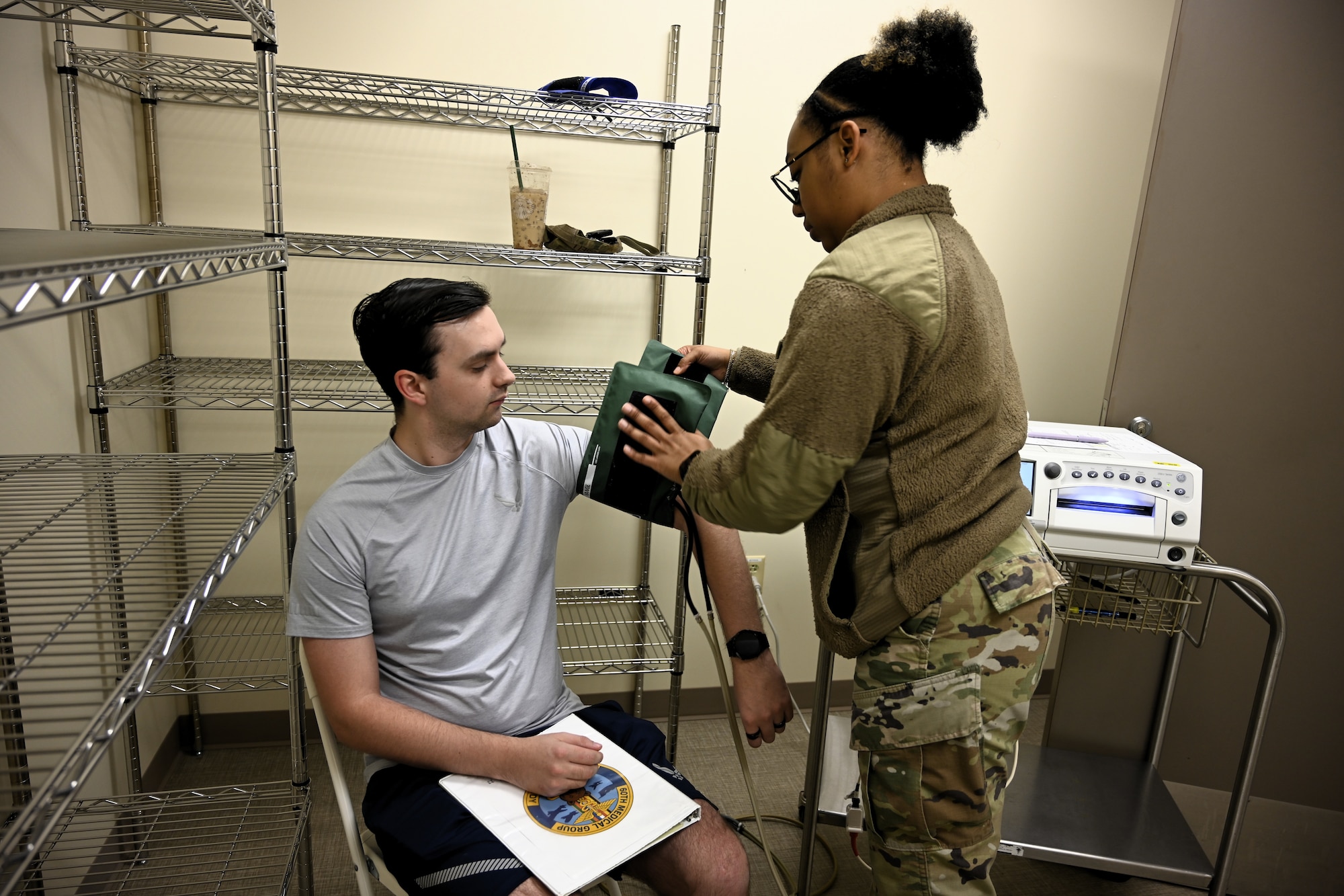 An Airman with the 60th Medical Group performs a blood pressure screening during a Continuous Medical Readiness event at David Grant USAF Medical Center, Travis Air Force Base, Calif., February 24, 2026. The initiative is designed to improve coordination between specialty clinics and accelerate deployment status updates.