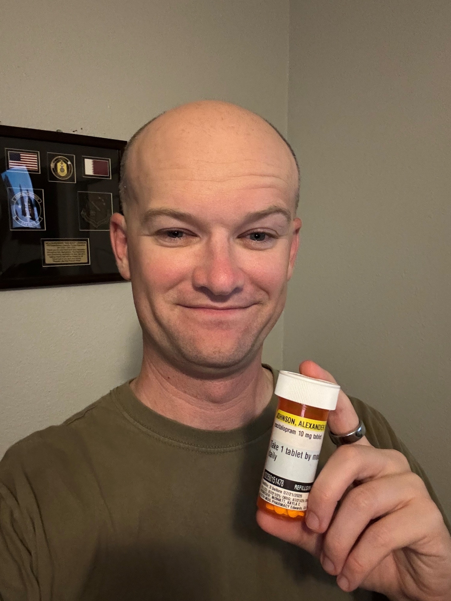 Capt. Alexander Johnson, 412th Security Forces Squadron director of operations, takes a photo of himself with his prescription bottle. Johnson shared the same photo on his social media to normalize seeking mental health treatment and to show his Airmen and other service members that asking for help does not automatically end a military career. (Courtesy photo)