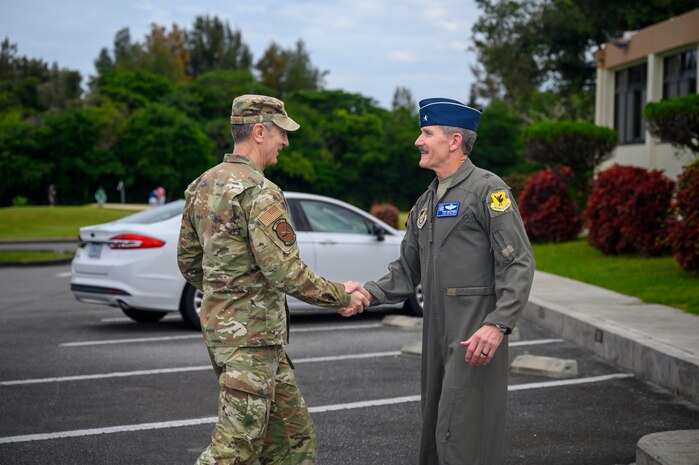 U.S. Air Force Gen. Kevin Schneider, left, Pacific Air Forces commander, is greeted by Brig. Gen. John Gallemore, 18th Wing commander, during a visit at Kadena Air Base, Japan, April 29, 2026. The engagement showcased Kadena’s role in sustaining combat power across the Indo-Pacific. (U.S. Air Force photo by Airman 1st Class Francisco Huerta)