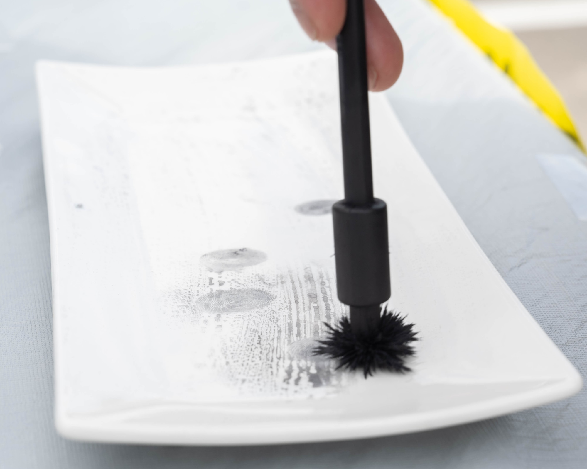 A participant tries out fingerprint lifting.