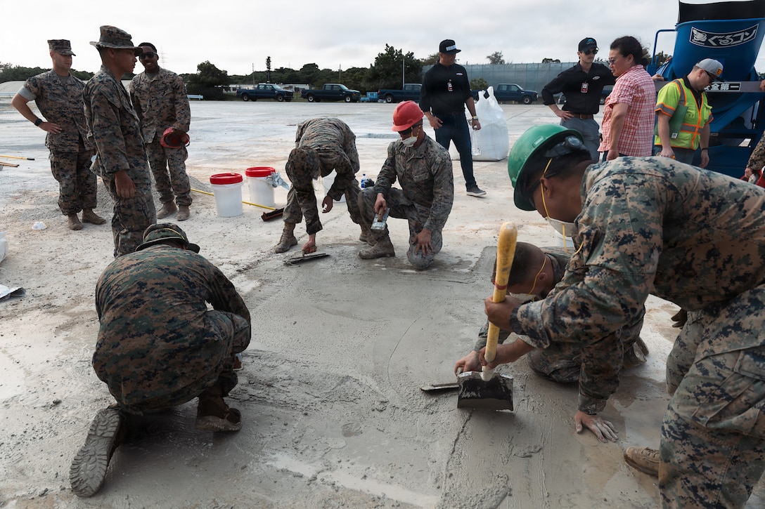 U.S. Marines with Marine Wing Support Squadron 172, Marine Aircraft Group 36, 1st Marine Aircraft Wing level wet concrete during airfield damage repair training on Kadena Air Base, Okinawa, Japan, April 14, 2026. MWSS-172 trained in rapid response airfield damage repair to simulate restoring minimum operating runway capability in a wartime environment. (U.S. Marine Corps photo by Cpl. Jeremiah Barksdale)