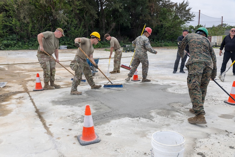 U.S. Airmen with the 18th Civil Engineer Squadron, 18th Wing and U.S. Marines with Marine Wing Support Squadron 172, Marine Aircraft Group 36, 1st Marine Aircraft Wing clean up after airfield damage repair training on Kadena Air Base, Okinawa, Japan, April 15, 2026. MWSS-172 and 18th CES trained in rapid response airfield damage repair to simulate restoring minimum operating runway capability in a wartime environment. (U.S. Marine Corps photo by Cpl. Jeremiah Barksdale)