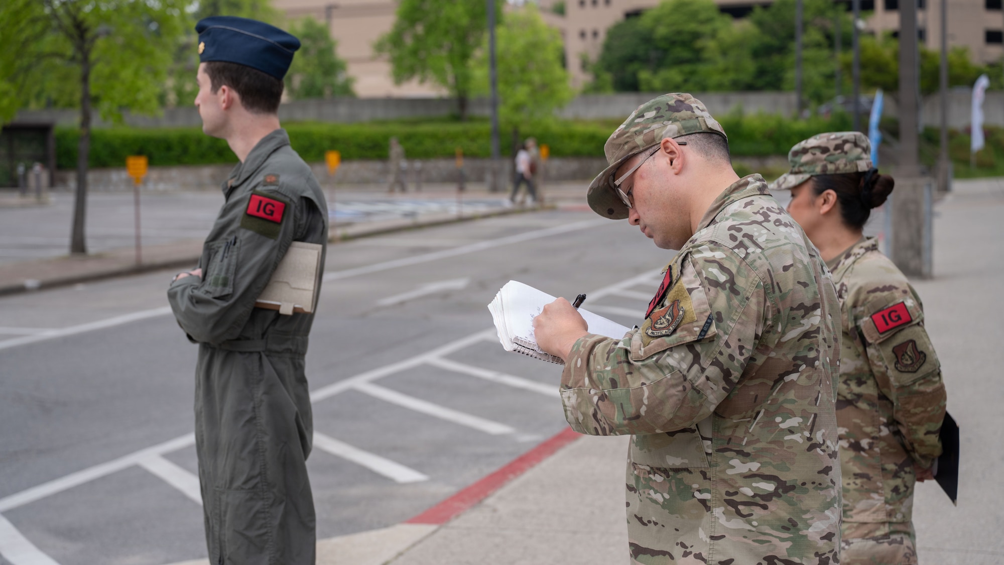 U.S. Air Force Master Sgt. Carl Ditty, 51st Fighter Wing Inspector General exercise superintendent, documents a simulated bomb threat during Mustang Rodeo at Osan Air Base, Republic of Korea, May 11, 2026. Wing Inspection Team members observed the exercise to evaluate response procedures and ensure participating agencies executed required actions throughout the scenario. (U.S. Air Force photo by Senior Airman Rome Bowermaster)