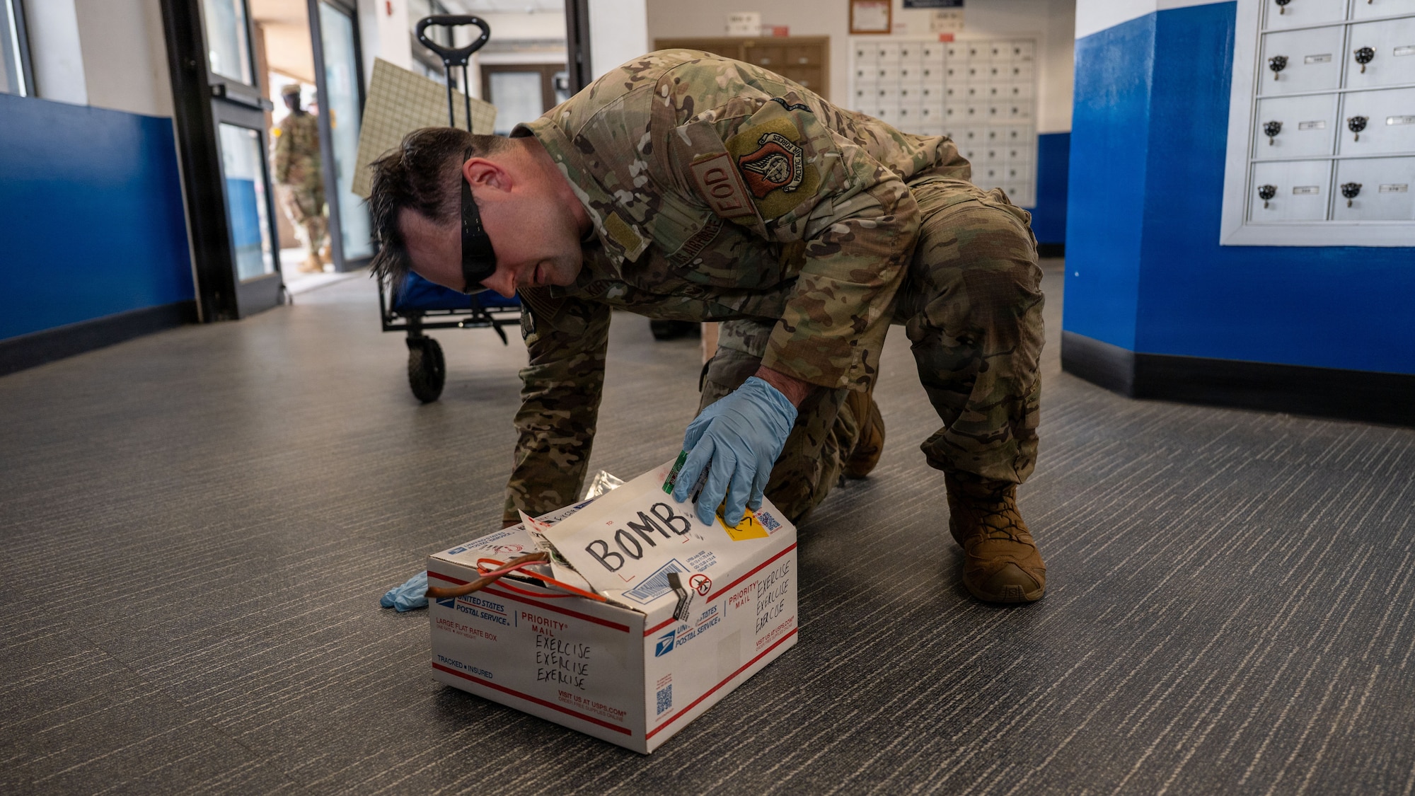 U.S. Air Force Staff Sgt. Wade Kirwan, 51st Civil Engineer Squadron non commissioned officer in charge of training, performs explosive ordinance and disposal methods in response to a simulated bomb threat during Mustang Rodeo at Osan Air Base, Republic of Korea, May 11, 2026. The scenario tested the ability of responding agencies to rapidly coordinate and execute emergency response procedures during a notional incident. (U.S. Air Force photo by Senior Airman Rome Bowermaster)