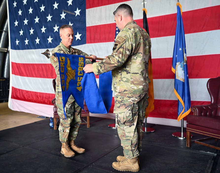 U.S. Air Force Col. Damon Field, 435th Contingency Response Group commander, and U.S. Air Force Lt. Col. David Deal, 435th Tactical Advisory Squadron commander, furl the 435th Contingency Response Support Squadron flag for the last time as the squadron is redesignated the 435 TAS May 8, 2026, at Ramstein Air Base, Germany.