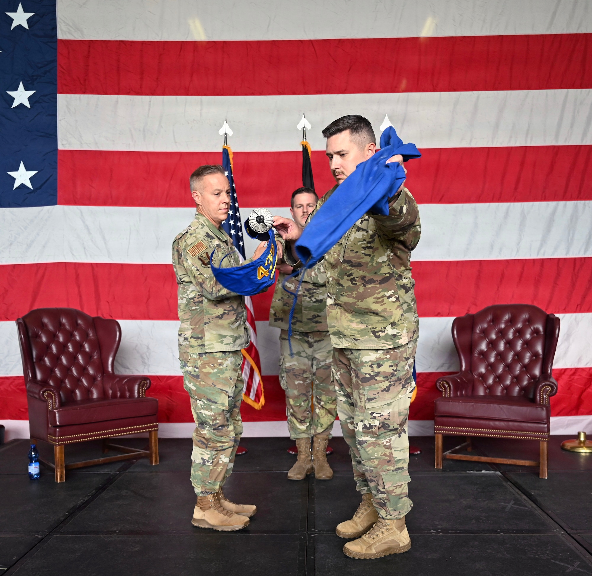 U.S. Air Force Col. Damon Field, 435th Contingency Response Group commander, and U.S. Air Force Lt. Col. David Deal, 435th Tactical Advisory Squadron commander, unfurl the 435 TAS flag for the first time during the redesignation ceremony May 8, 2026, at Ramstein Air Base, Germany.