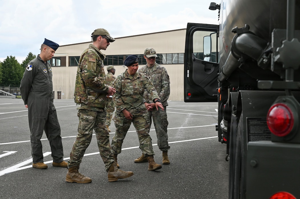 A group of people tour a truck.