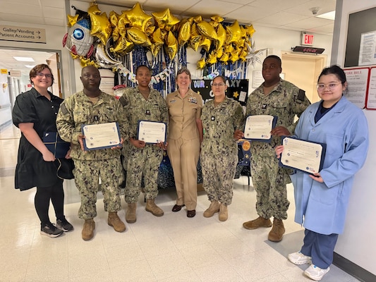 260424-N-LY941-4009
GUANTANAMO BAY, Cuba - Members of the laboratory team at U.S. Naval Hospital Guantanamo Bay receive a Ready Reliable Care Reliability in Action Certificate of Recognition at the hospital, April 24, 2026. The team earned the award for exemplifying the Ready Reliable Care principle of commitment to resilience. Awardees from left to right are:  Lt. j.g. Keron Liverpool, Hospital Corpsman 2nd Class Asia Shelton, Hospital Corpsman 3rd Class Jmere Robinson Witherspoon, and Hospital Corpsman 2nd Class Selena Mangosing. (U.S. Navy photo by Emily McCamy)