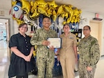 260424-N-LY941-4008
GUANTANAMO BAY, Cuba - Information Systems Technician Seaman Aaron Mendez receives a Reliability in Action Certificate of Recognition at U.S. Naval Hospital Guantanamo Bay, April 24, 2026. Mendez, a member of U.S. Navy Medicine Readiness and Training Command Guantanamo Bay, was recognized for his reluctance to simplify, working to understand complex systems and address root causes to strengthen patient safety and operational effectiveness. (U.S. Navy photo by Emily McCamy)