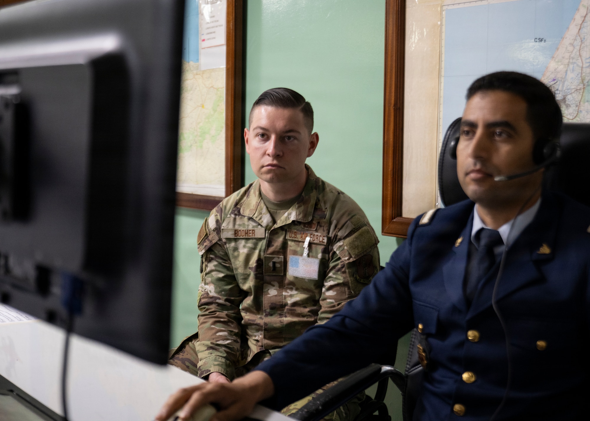 two men looking at a screen