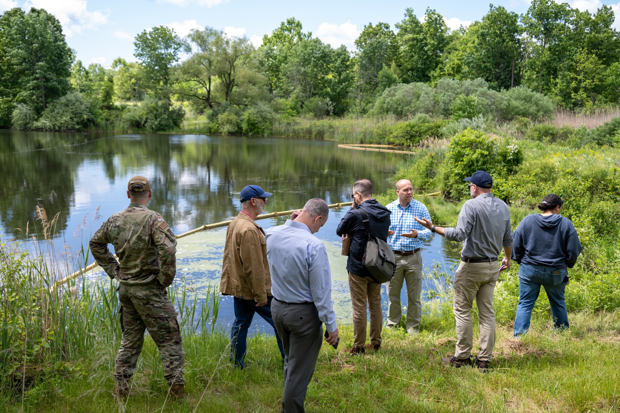 Restoration Advisory Board members by a pond