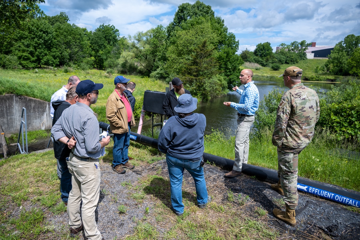Restoration Advisory Board members by a pond