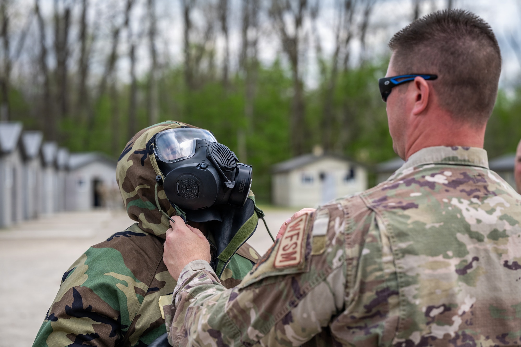 Airman fixes a gas mask