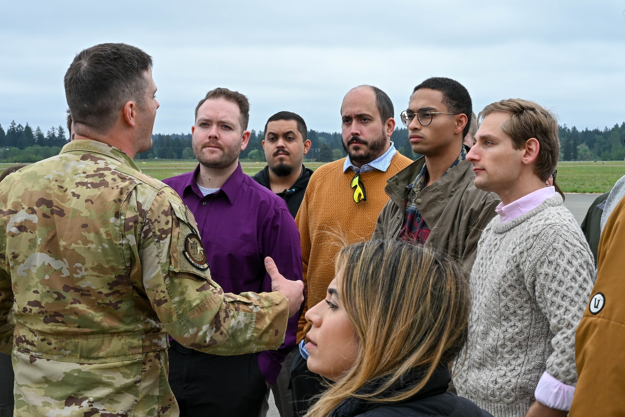 A man speaks to a group of people.