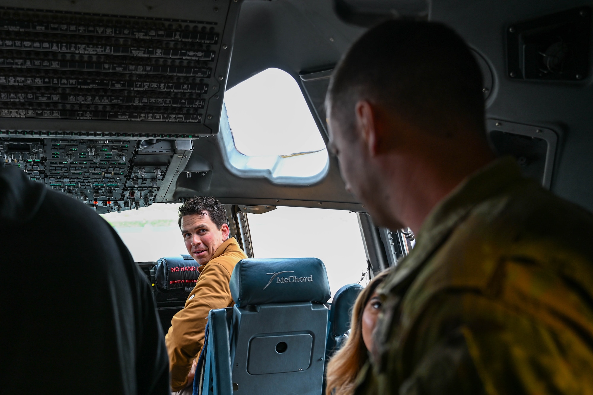 A man sits in the cockpit of an aircraft.