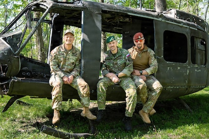 Indiana National Guard Master Sgt. Thuc Tran, the operations sergeant for Indiana's State Partnership Program, Sgt. Ondrej Macak and Sgt. 1st Class Matus Fulop, soldiers with the Slovak Armed Forces, pose for a photo at Camp Atterbury, near Edinburgh, Indiana, April 4, 2026.