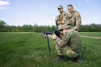 Indiana National Guard Master Sgt. Thuc Tran, center, the operations sergeant for Indiana's State Partnership Program, observes soldiers from the Slovak Armed Forces as they fire their M4 carbine at Camp Atterbury, near Edinburgh, Indiana, April 4, 2026.