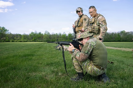Indiana National Guard Master Sgt. Thuc Tran, center, the operations sergeant for Indiana's State Partnership Program, observes soldiers from the Slovak Armed Forces as they fire their M4 carbine at Camp Atterbury, near Edinburgh, Indiana, April 4, 2026.