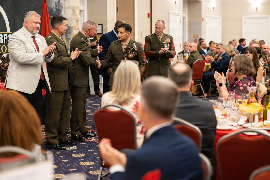 The 39th Commandant of the Marine Corps, Gen. Eric M. Smith, congratulates the U.S. Marine Corps GySgt Sebastian Torres, the 2026 Formal Enlisted Instructor of the Year award recipient, during the Annual Training and Education Command (TECOM) Awards Dinner at Marine Corps Base Quantico, Virginia, May 7, 2026. The dinner is an annual award ceremony that recognizes individual U.S. Marines and civilian instructors from across TECOM for their superior performance. (U.S. Marine Corps photo Cpl. Juaquin Greaves)