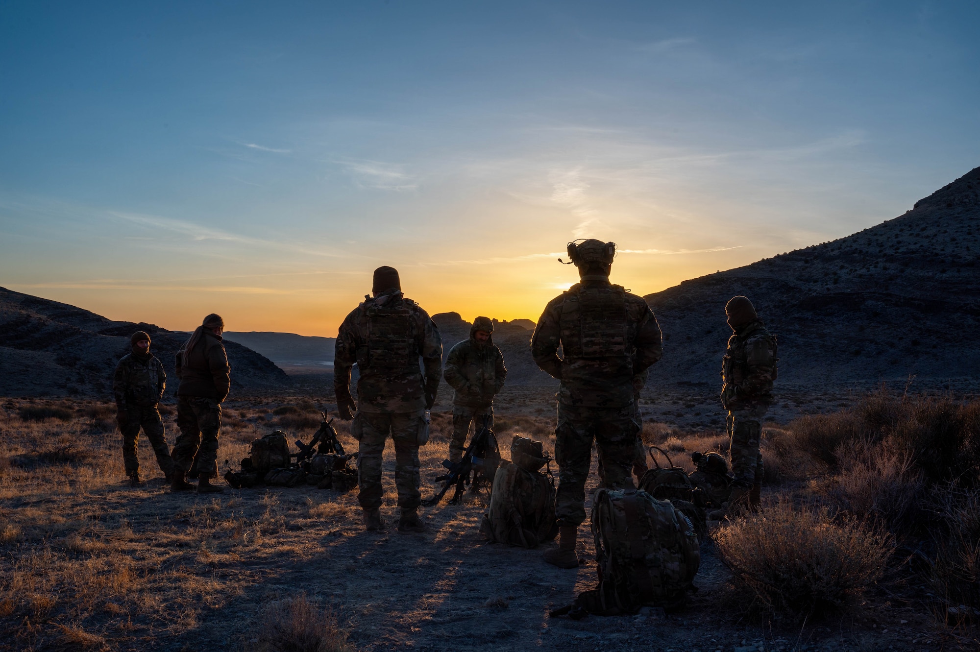 Airmen standing in a desert