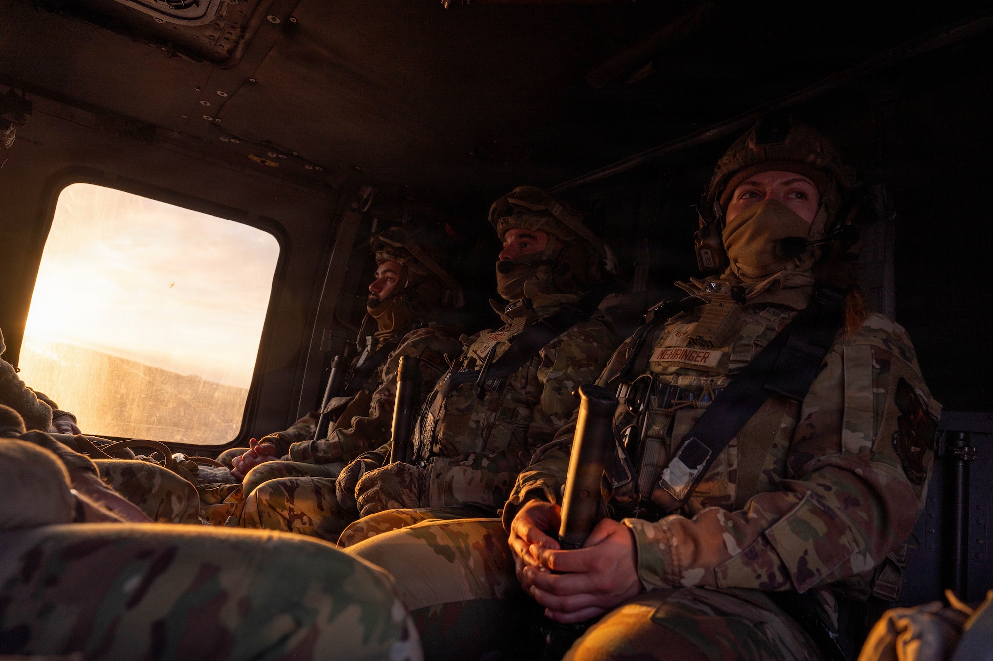 Airmen sitting in a helicopter