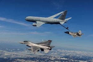 A KC-46 Pegasus assigned to the 418th Flight Test Squadron, Global Reach Combined Test Force, refuels an F-22 Raptor assigned to the 411th Flight Test Squadron, Air Dominance Combined Test Force while an F-16 assigned to the 416th Flight Test Squadron, Airpower Foundations Combined Test Force, awaits a turn over the Mojave Desert, March 3, 2026. Partnerships between the Combined Test Forces at Edwards Air Force Base, Calif., help expedite critical capability for the warfighter by leveraging multiple program portfolios in tandem. In this scenario, the F-16 aircraft was operating as a target for key F-22 Raptor test points while the KC-46 was able to collect additional data for aerial refueling efforts. (Courtesy photo)