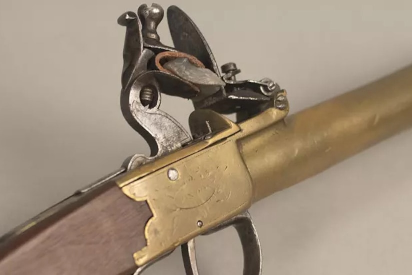 A pistol trigger mechanism is on display.
