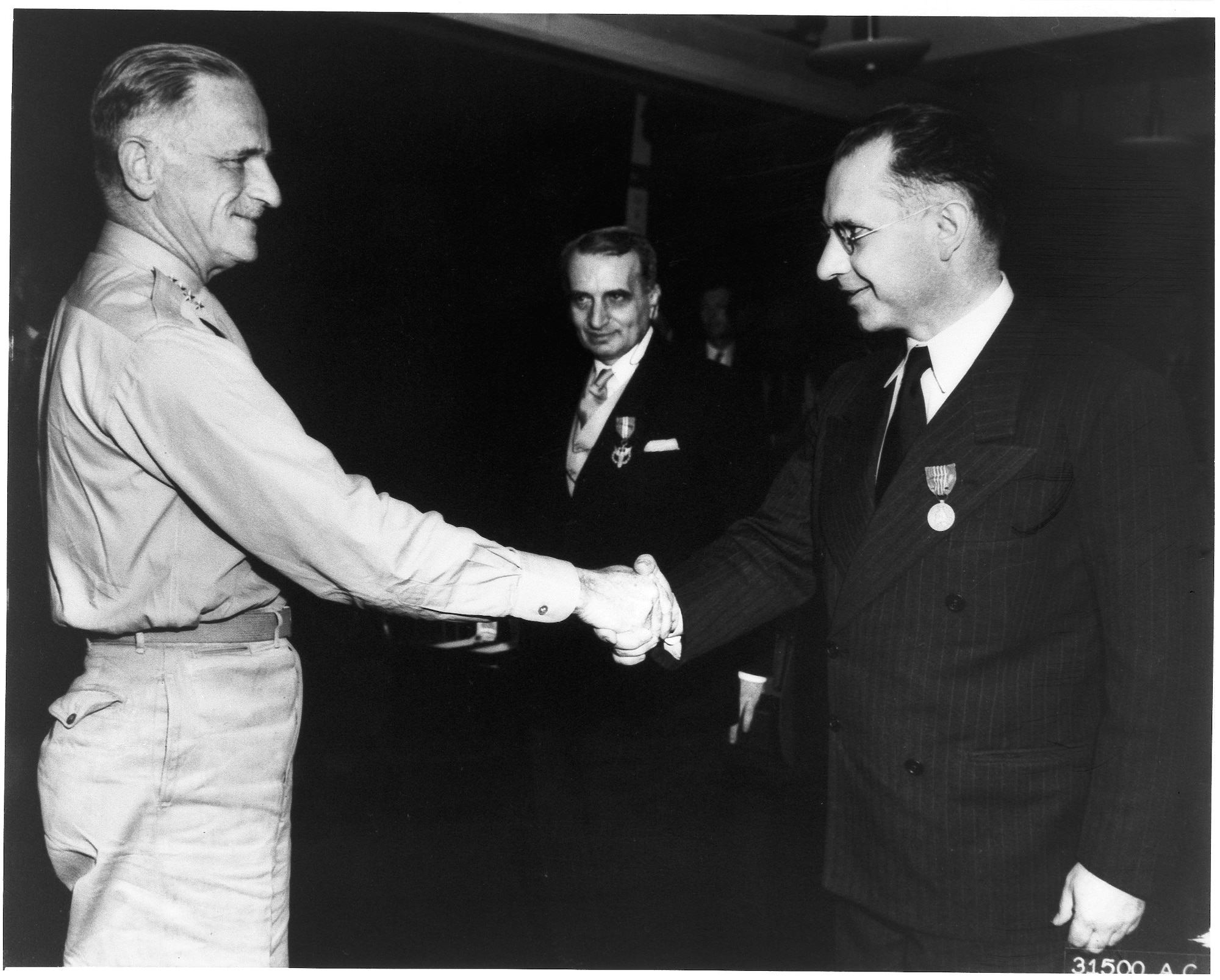 American scientist Frank Wattendorf, right, receives an award from then-Air Force Chief of Staff Gen. Carl Spaatz as Theodore von Kármán, center, looks on. Wattendorf is considered one of the founding fathers of Arnold Engineering Development Center. His Trans-Atlantic Memo, written following a 1945 survey of captured German test facilities with other members of the Scientific Advisory Group, was the first recommendation of a facility such as AEDC. (U.S. Air Force photo)