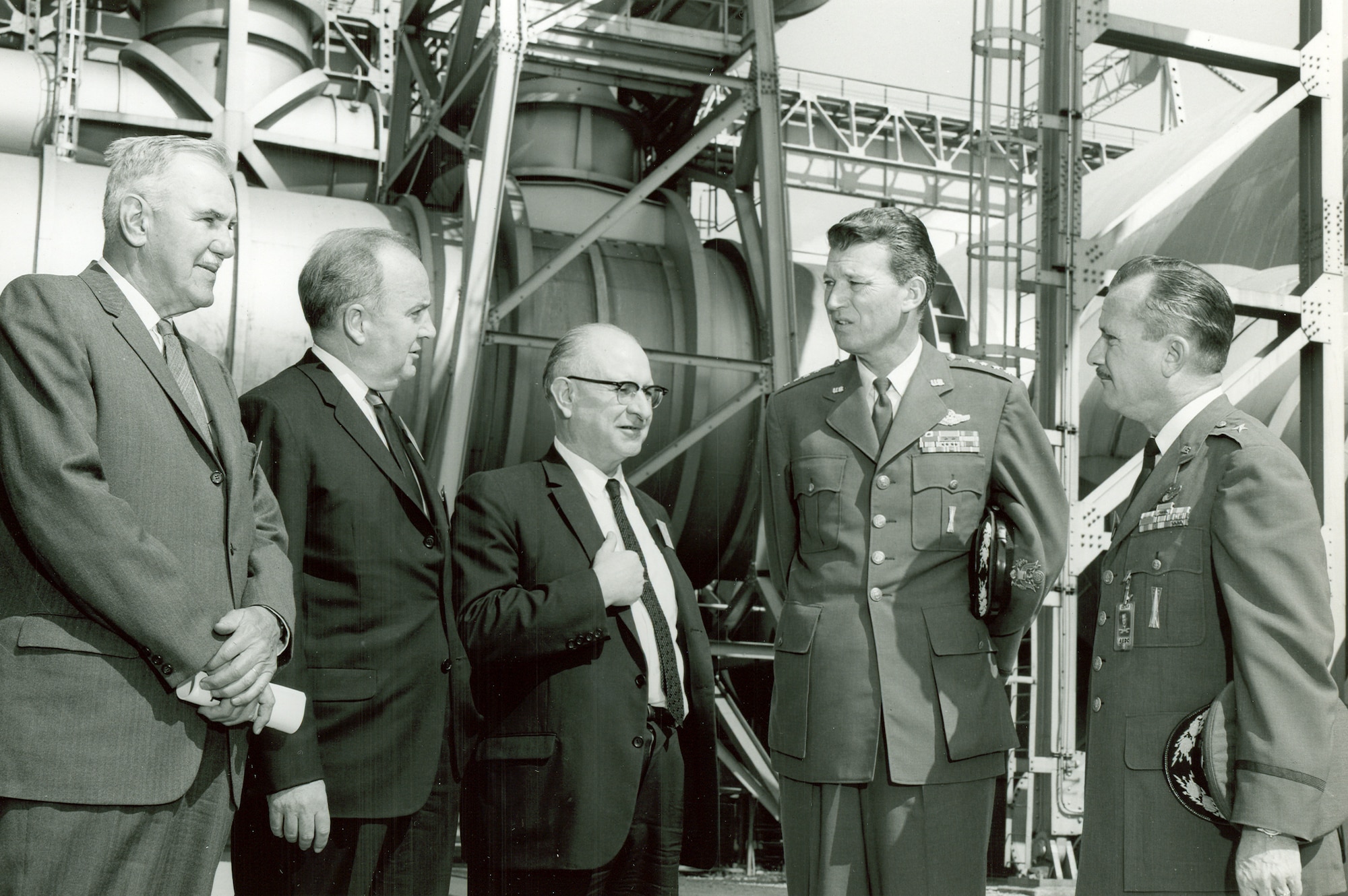 American scientist Frank Wattendorf, center, joins other Air Force and Arnold Engineering Development Center officials in a tour of the center in 1965. Wattendorf is considered one of the founding fathers of AEDC. His Trans-Atlantic Memo, written following a 1945 survey of captured German test facilities with other members of the Scientific Advisory Group, was the first recommendation of a facility such as AEDC. Also pictured, from left, are retired Maj. Gen. Franklin O. Carroll, R.M. Williams, Gen. Bernard Schriever and then-AEDC Commander Brig. Gen. Lee Gossick. (U.S. Air Force photo)