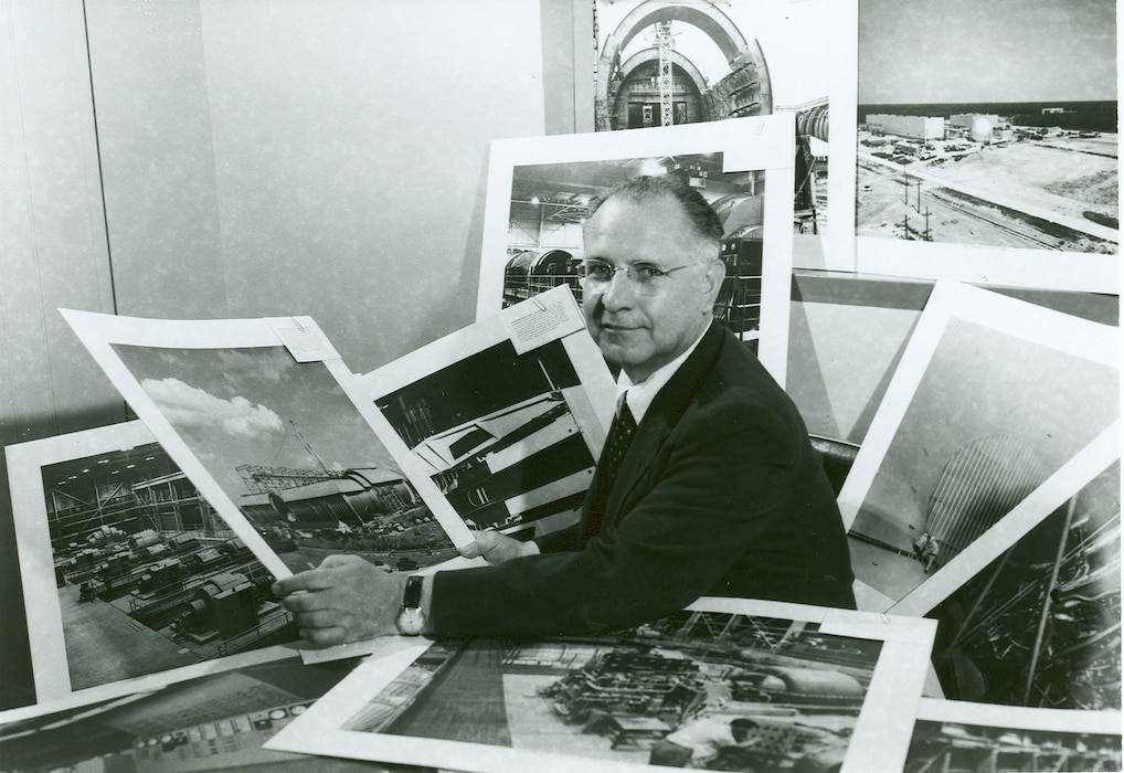 American scientist Frank Wattendorf looks over Arnold Engineering Development Center construction photographs in this image taken in the 1950s. Wattendorf is considered one of the founding fathers of AEDC. His Trans-Atlantic Memo, written following a 1945 survey of captured German test facilities with other members of the Scientific Advisory Group, was the first recommendation of a facility such as AEDC. (U.S. Air Force photo)