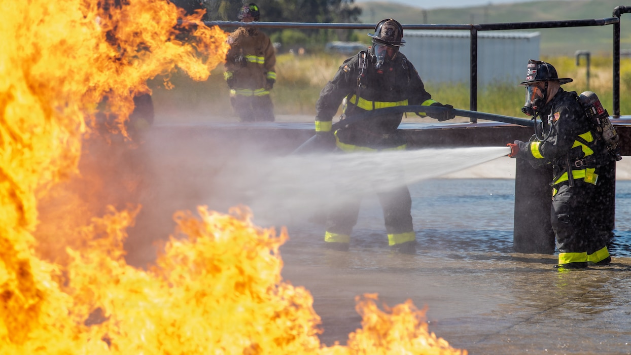 Firefighters combat a simulated aircraft fire
