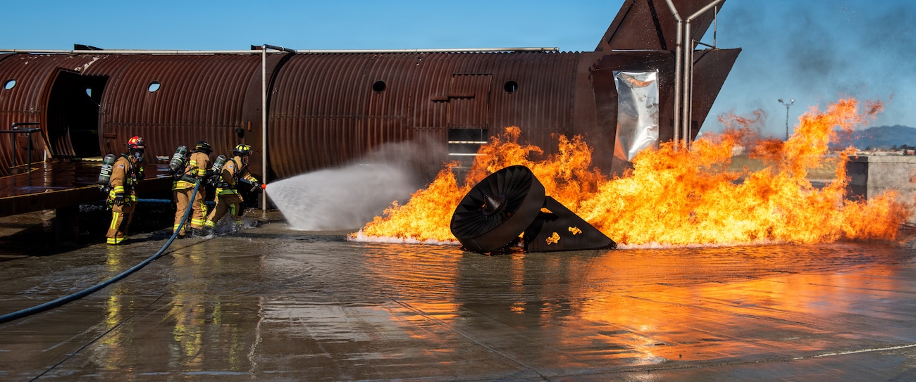 Firefighters combat a simulated aircraft fire