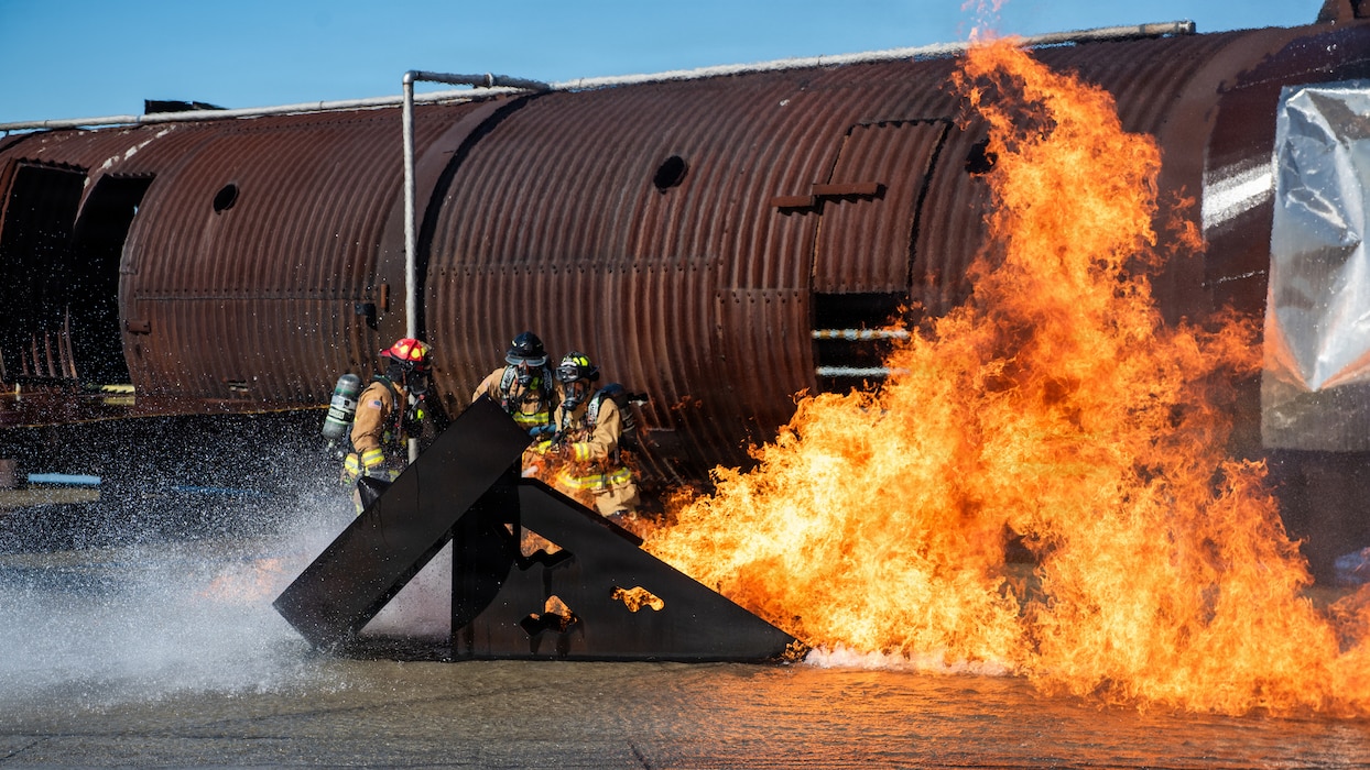 Firefighters combat a simulated aircraft fire