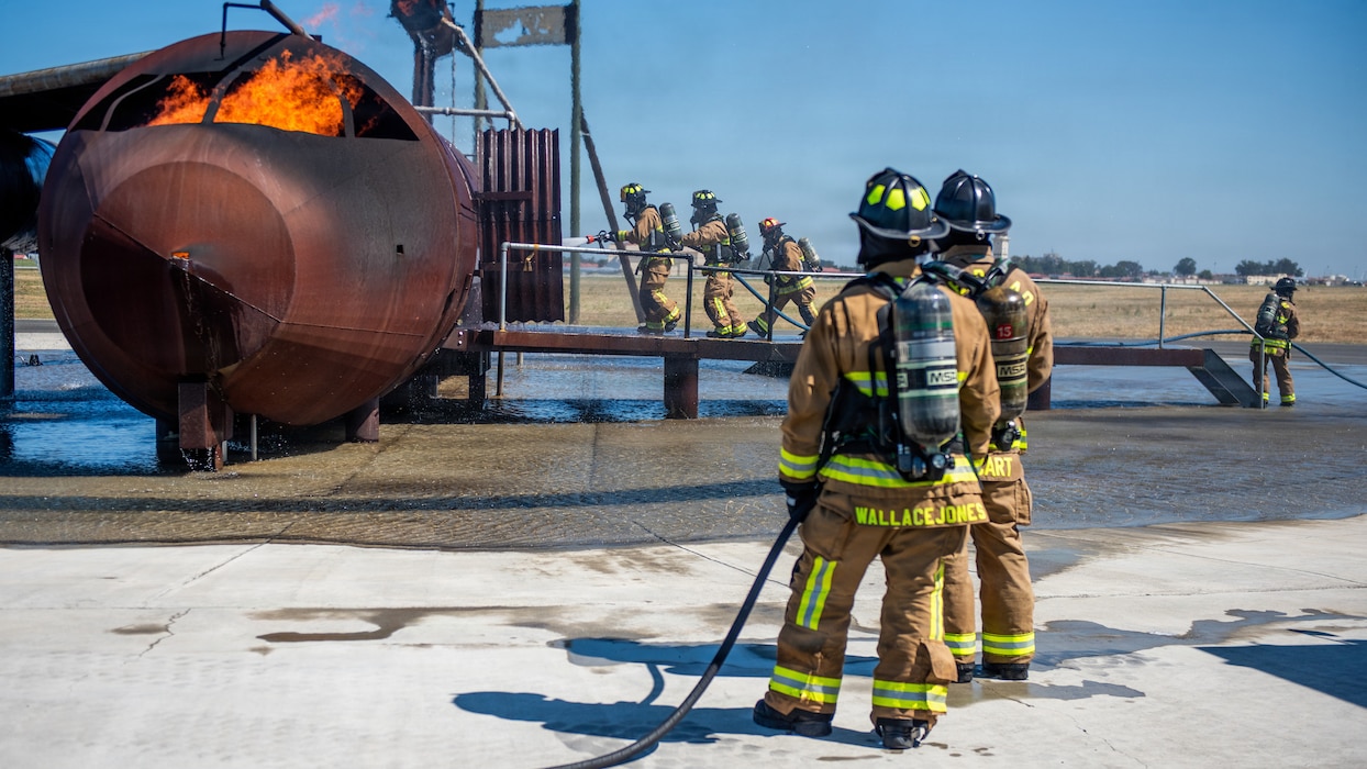 Firefighters combat a simulated aircraft fire
