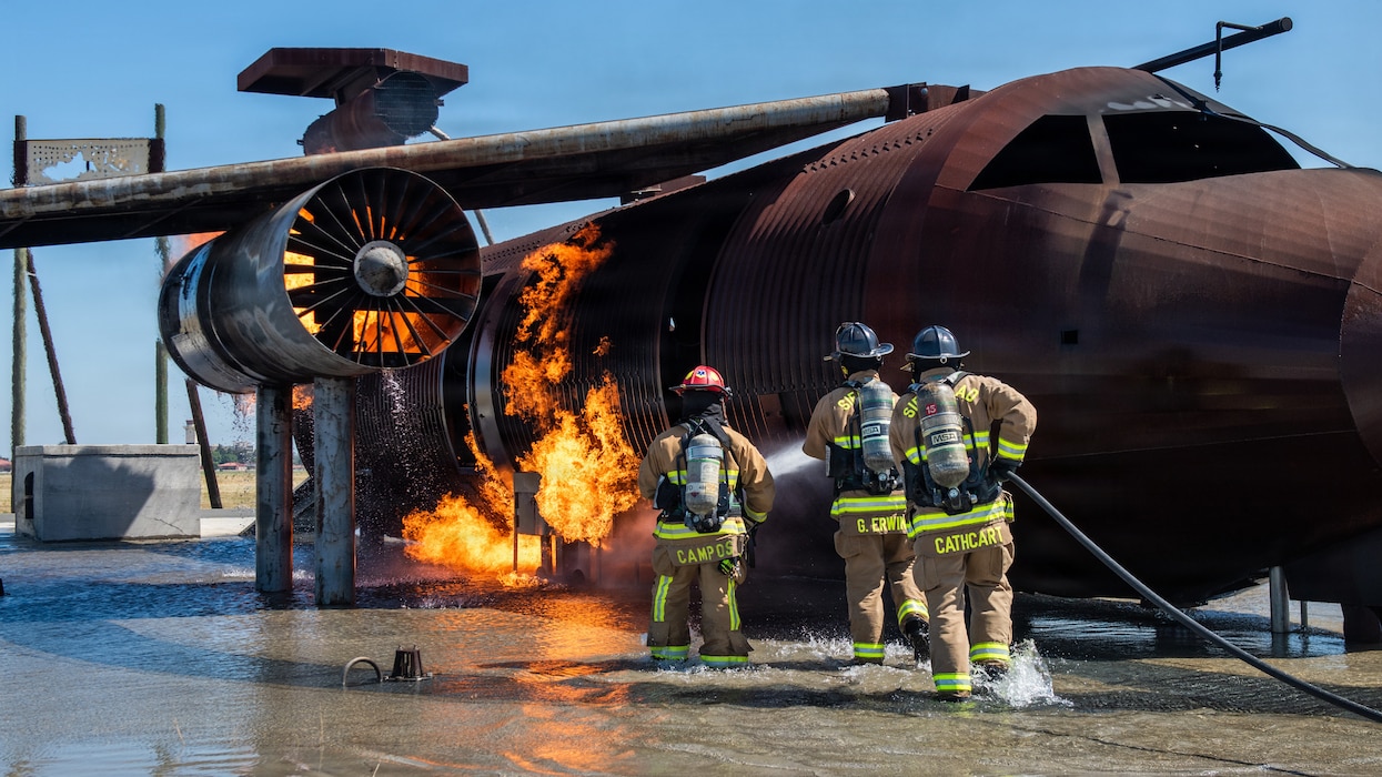 Firefighters combat a simulated aircraft fire
