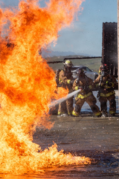 Firefighters combat a simulated aircraft fire