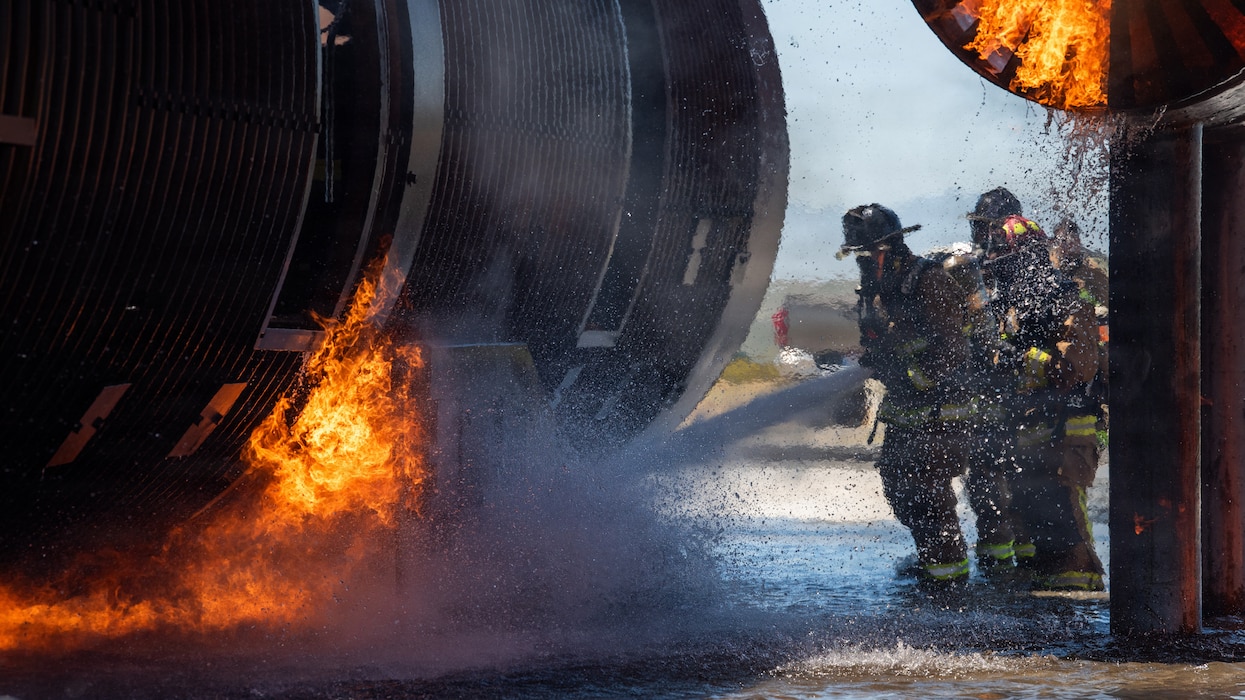 Firefighters combat a simulated aircraft fire