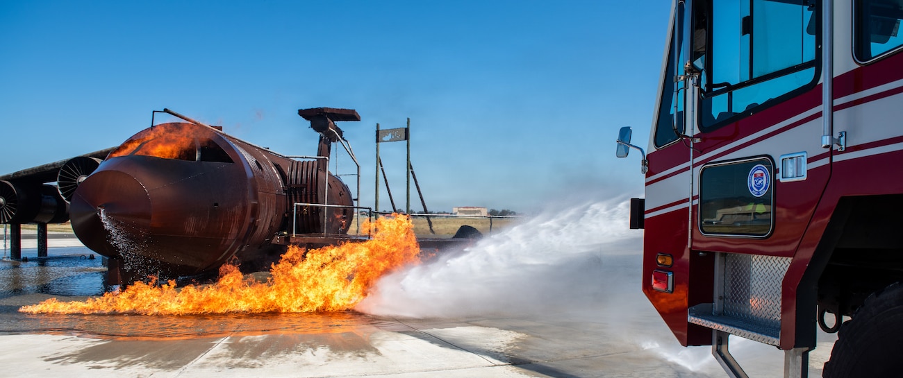 Firefighters combat a simulated aircraft fire