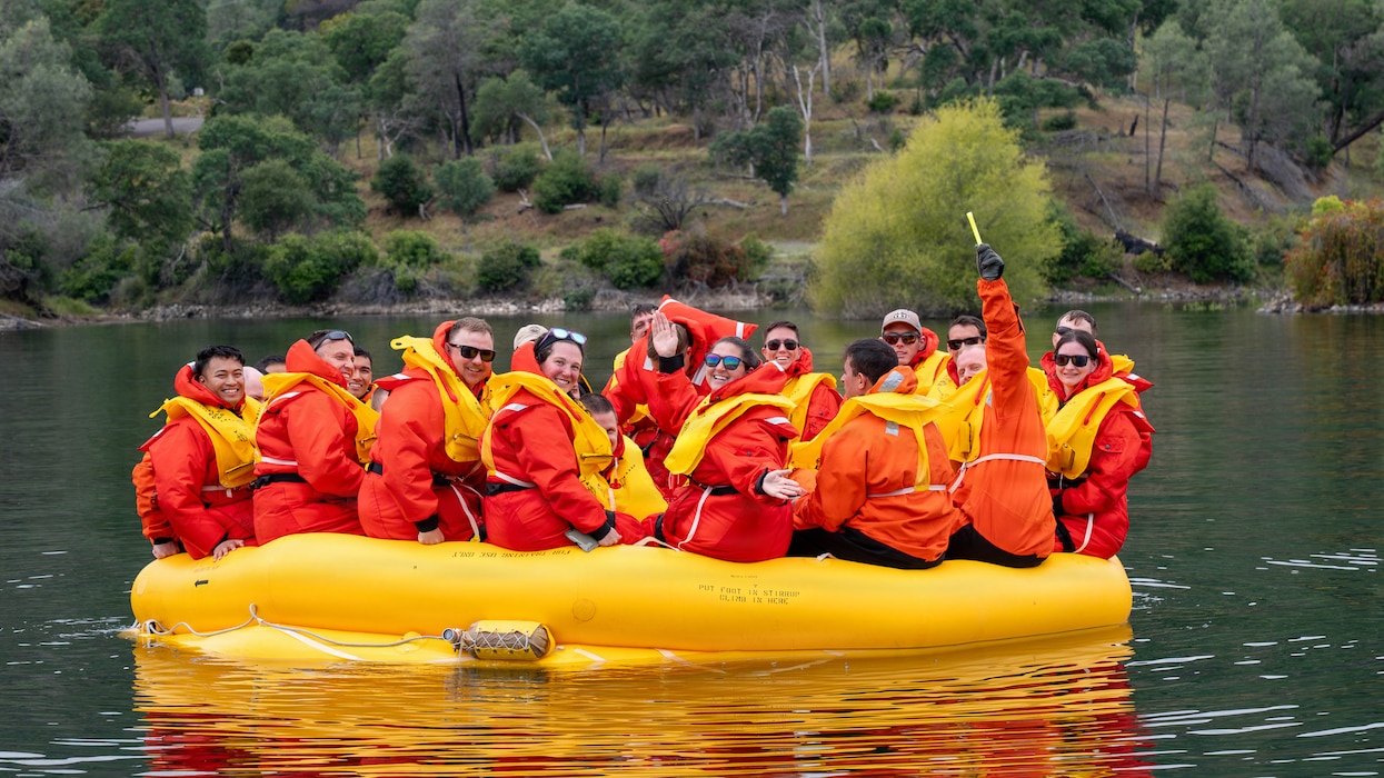 a group of people sitting in a raft in water
