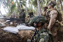 U.S. Marines assigned to 1st Battalion, 5th Marine Regiment, Marine Rotational Force – Darwin, and Philippine marines stand by to engage during a counter-landing live-fire exercise as part of Exercise Balikatan 2026 in Aporawan, Philippines, April 27, 2026.