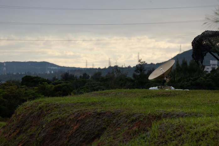 A U.S. Marine Corps wideband satellite-expeditionary assigned to 7th Communication Battalion, III Marine Expeditionary Force Information Group, operates atop a hill during Kaiju Rain 26 at Camp Hansen, Okinawa, Japan, May 6, 2026.