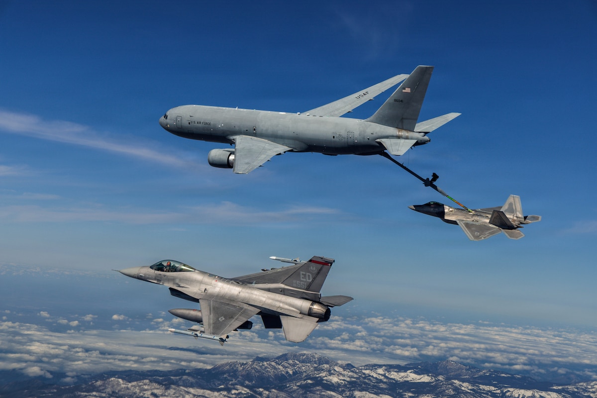 A KC-46 Pegasus assigned to the 418th Flight Test Squadron, Global Reach Combined Test Force, refuels an F-22 Raptor assigned to the 411th Flight Test Squadron, Air Dominance Combined Test Force while an F-16 assigned to the 416th Flight Test Squadron, Airpower Foundations Combined Test Force, awaits a turn over the Mojave Desert, March 3, 2026. Partnerships between the Combined Test Forces at Edwards Air Force Base, Calif., help expedite critical capability for the warfighter by leveraging multiple program portfolios in tandem. In this scenario, the F-16 aircraft was operating as a target for key F-22 Raptor test points while the KC-46 was able to collect additional data for aerial refueling efforts. (Courtesy photo)