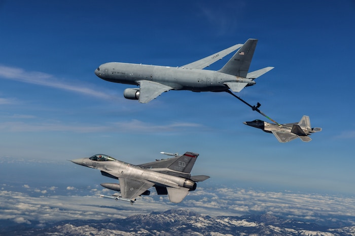 A KC-46 Pegasus assigned to the 418th Flight Test Squadron, Global Reach Combined Test Force, refuels an F-22 Raptor assigned to the 411th Flight Test Squadron, Air Dominance Combined Test Force while an F-16 assigned to the 416th Flight Test Squadron, Airpower Foundations Combined Test Force, awaits a turn over the Mojave Desert, March 3, 2026. Partnerships between the Combined Test Forces at Edwards Air Force Base, Calif., help expedite critical capability for the warfighter by leveraging multiple program portfolios in tandem. In this scenario, the F-16 aircraft was operating as a target for key F-22 Raptor test points while the KC-46 was able to collect additional data for aerial refueling efforts. (Courtesy photo)