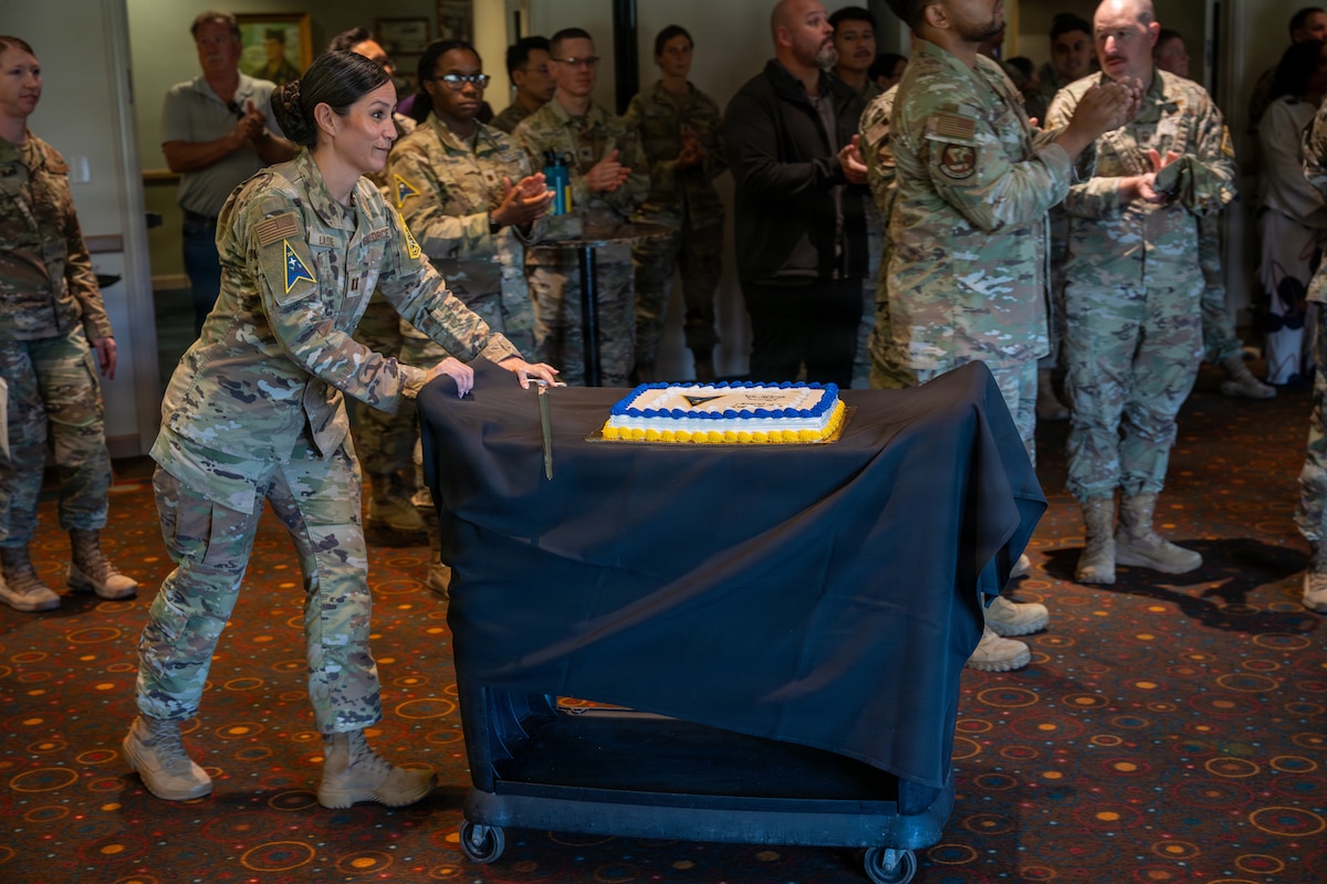 U.S. Air Force Capt. Courtney Ladue pushes a cake cart.