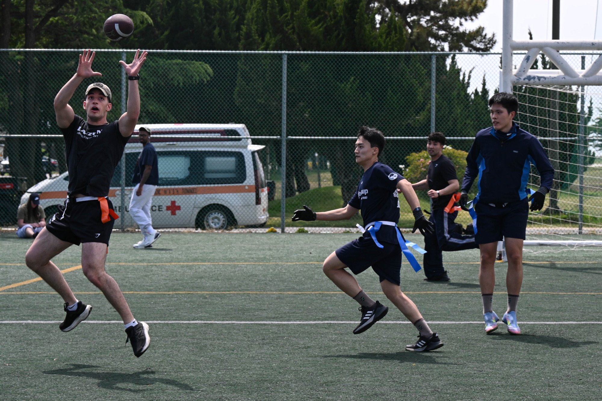 Service members play flag football.