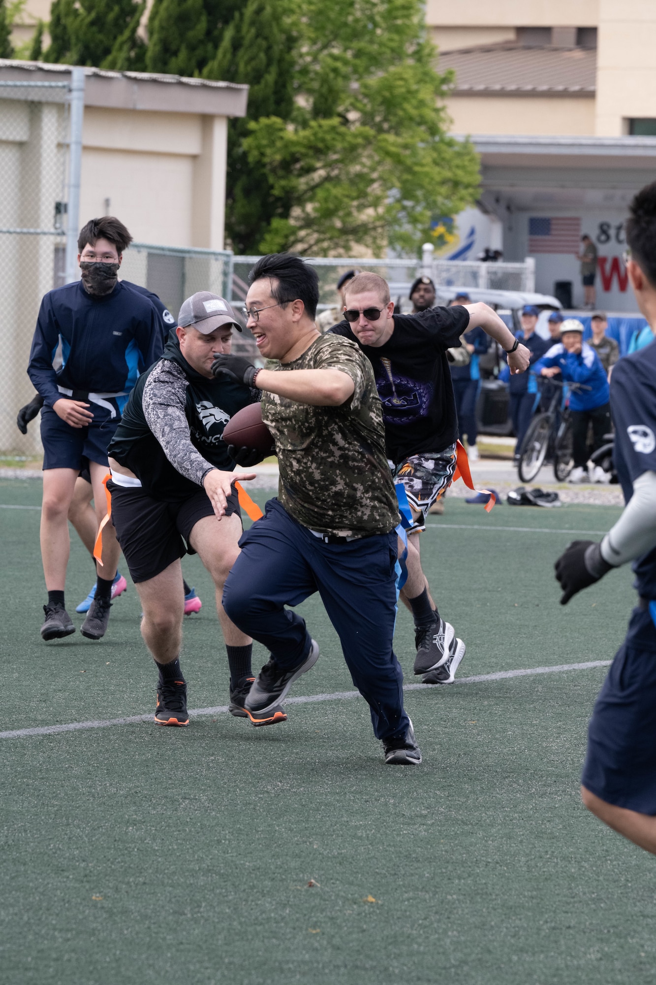 Service members play flag football.