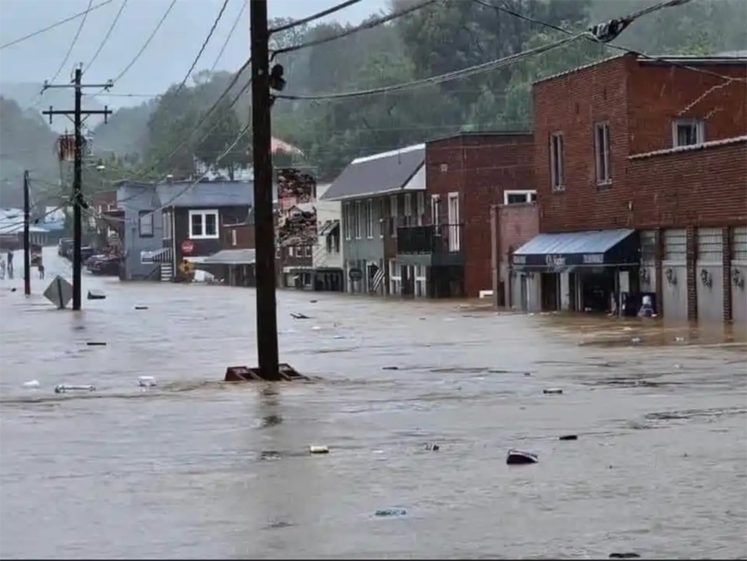A small town main street is flooded with several feet of water.