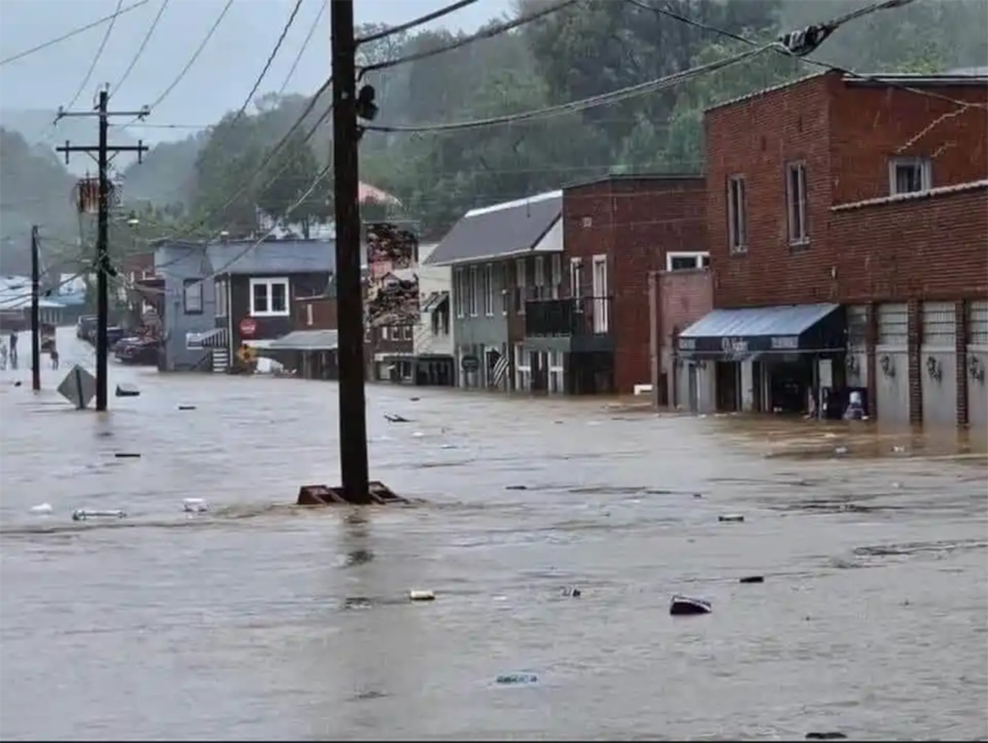 A small town main street is flooded with several feet of water.