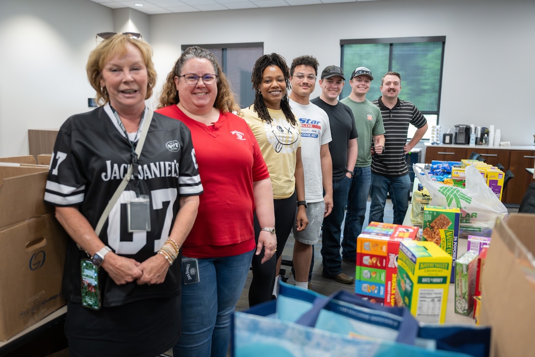 Members of the Arnold Engineering Development Complex Enlisted Force Council at Arnold Air Force Base, Tenn., volunteered time and efforts at the Jack Daniel Distillery in Lynchburg, Tenn. The Airmen helped sort items for care packages for deployed service members. Pictured from left are Moore County Chamber of Commerce President Marsha Hale, Jack Daniel Distillery Financial Analyst Robyn LaCook, Tech. Sgt. Antoinette Dupree, Senior Airman Franklin Ramirez Reyes, 1st Lt. Caleb Lynch, 2nd Lt. Christopher Lewis and Tech. Sgt. Abel Crowell. (U.S. Air Force photo by Kali Bradford)