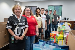 Members of the Arnold Engineering Development Complex Enlisted Force Council at Arnold Air Force Base, Tenn., volunteered time and efforts at the Jack Daniel Distillery in Lynchburg, Tenn. The Airmen helped sort items for care packages for deployed service members. Pictured from left are Moore County Chamber of Commerce President Marsha Hale, Jack Daniel Distillery Financial Analyst Robyn LaCook, Tech. Sgt. Antoinette Dupree, Senior Airman Franklin Ramirez Reyes, 1st Lt. Caleb Lynch, 2nd Lt. Christopher Lewis and Tech. Sgt. Abel Crowell. (U.S. Air Force photo by Kali Bradford)